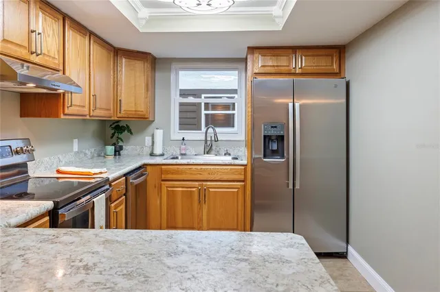 a view of a dining room with furniture and a chandelier fan