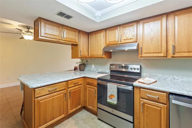 a view of a room with wooden floor and a ceiling fan