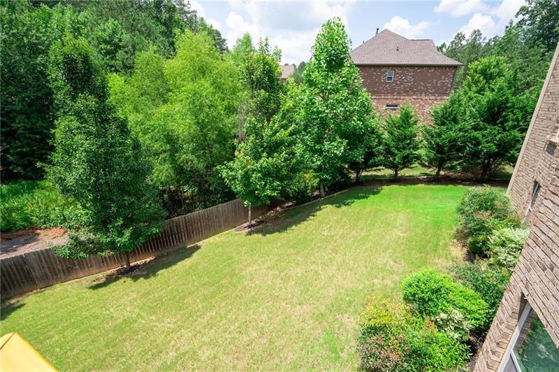 3225 Sundew Drive Acworth, GA 30101 - Photo 27 of 37 a view of a backyard with plants and a lake view