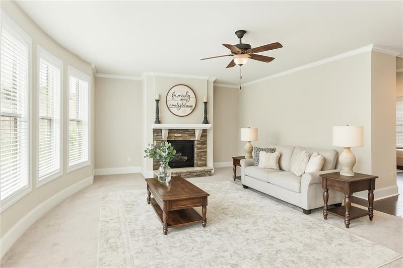 3225 Sundew Drive Acworth, GA 30101 - Photo 8 of 37 a living room with furniture a clock and a large window