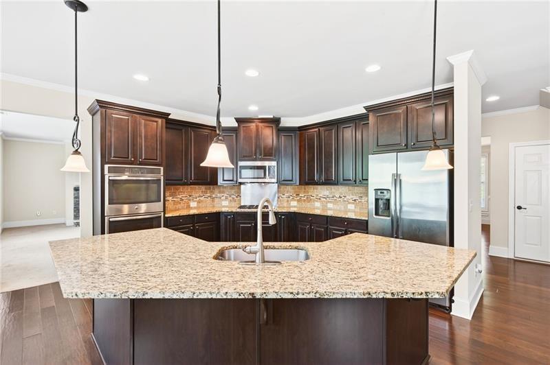 3225 Sundew Drive Acworth, GA 30101 - Photo 9 of 37 a kitchen with kitchen island granite countertop a sink a counter top stainless steel appliances and cabinets