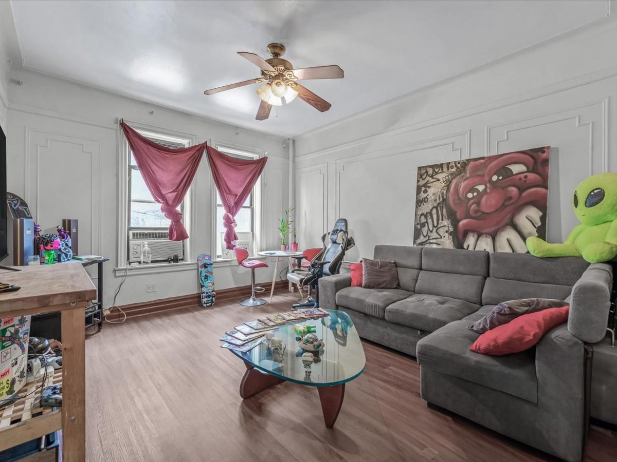 246 Cornelia Street, Unit B2 Brooklyn, NY 11221 - Photo 4 of 10 a living room with furniture and a chandelier
