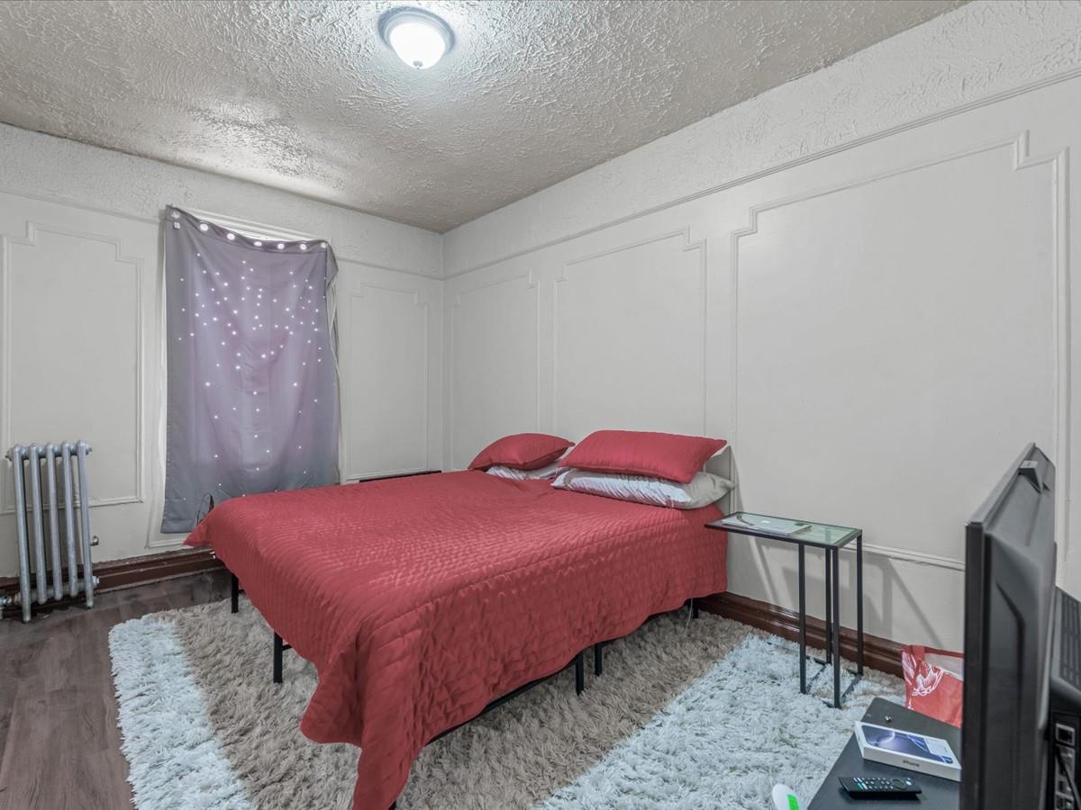 246 Cornelia Street, Unit B2 Brooklyn, NY 11221 - Photo 8 of 10 a bedroom with a bed and a flat screen tv