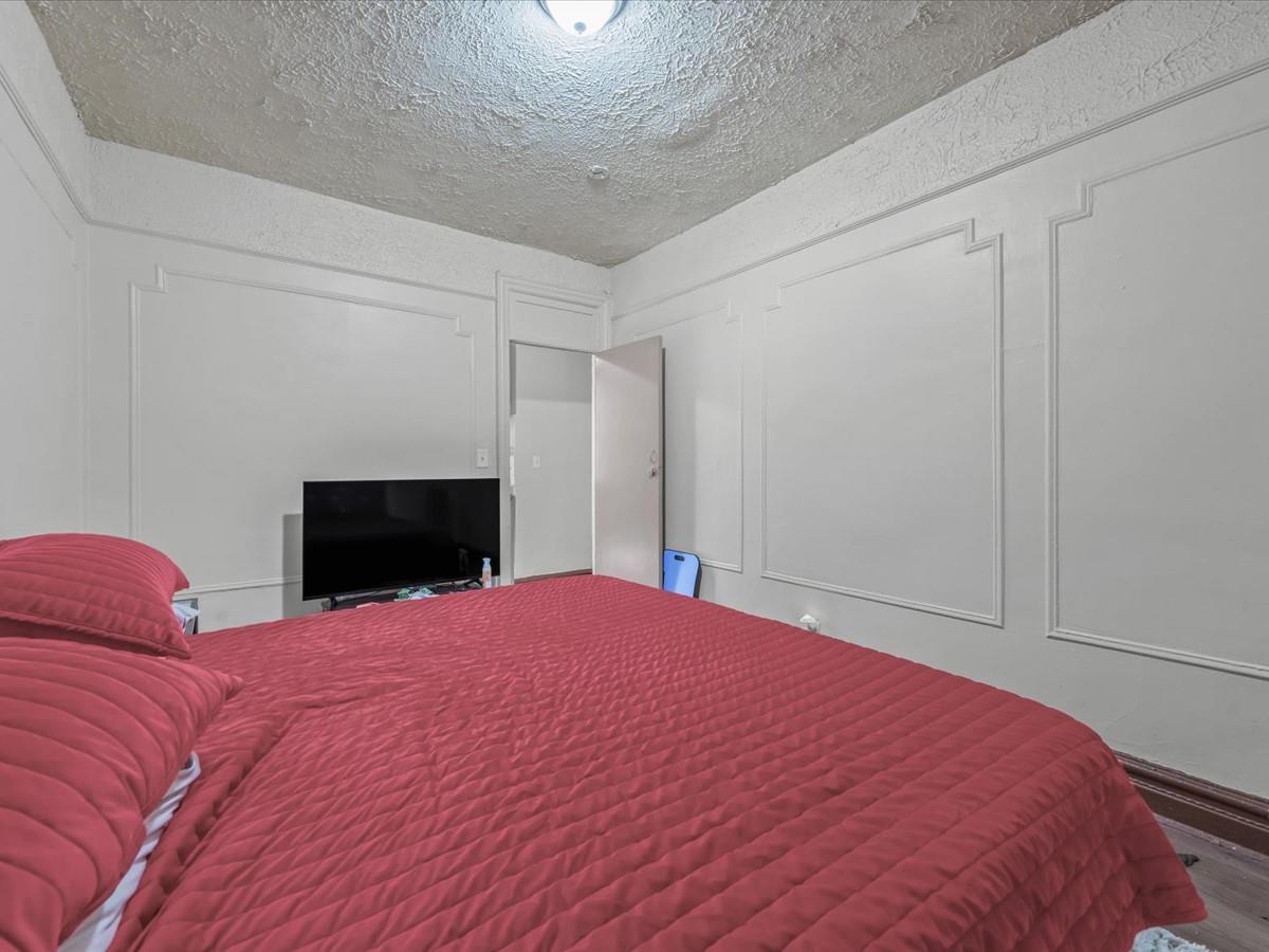 246 Cornelia Street, Unit B2 Brooklyn, NY 11221 - Photo 9 of 10 a bedroom with a bed and a fireplace