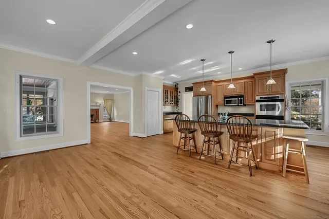a view of a kitchen with furniture and wooden floor