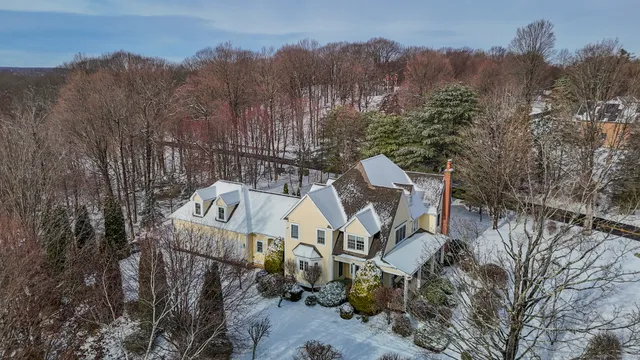 an aerial view of a house with a yard
