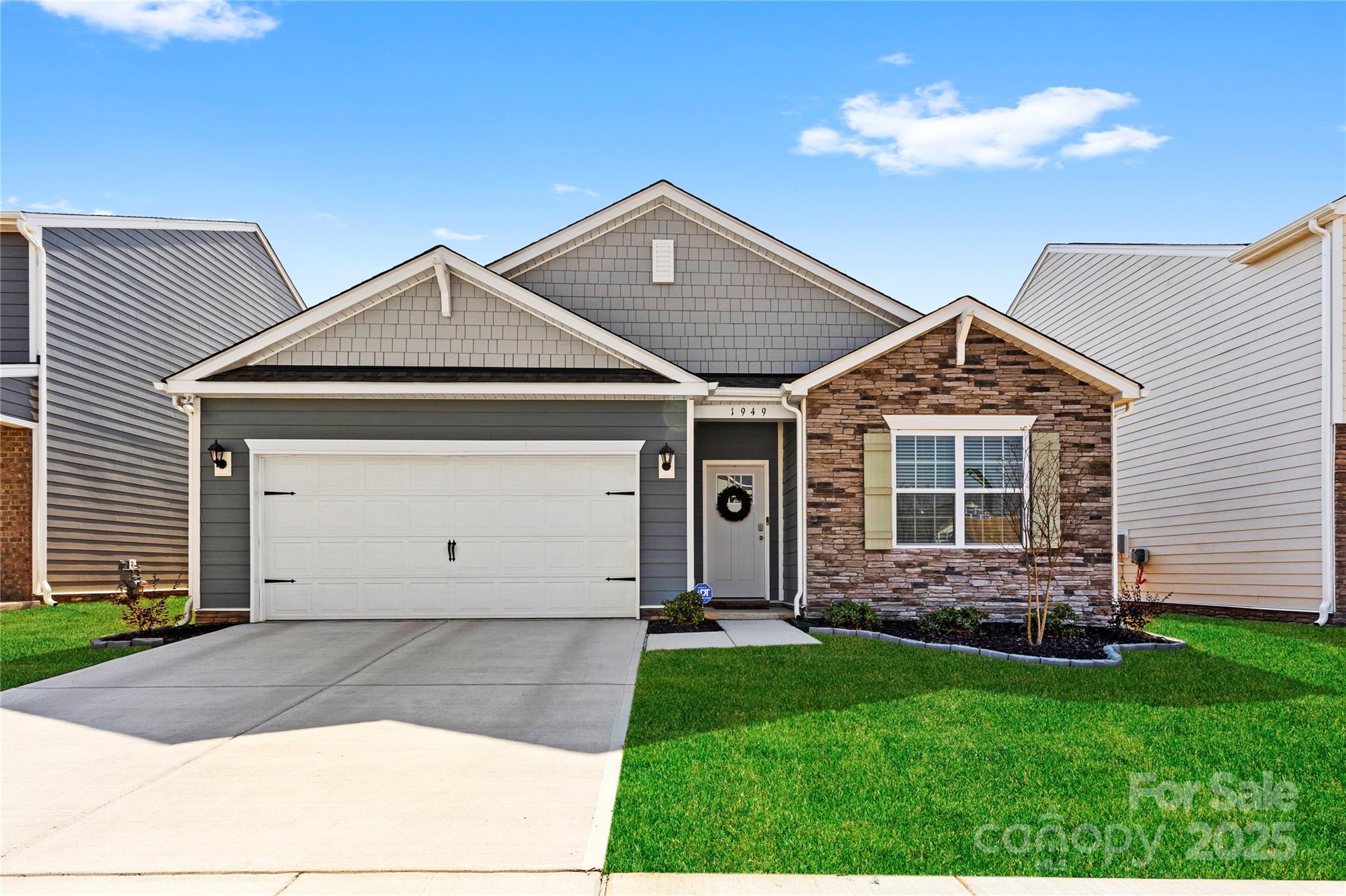 a front view of a house with a garden