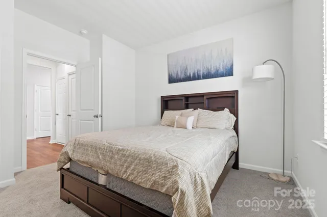 a bedroom with a bed and a painting