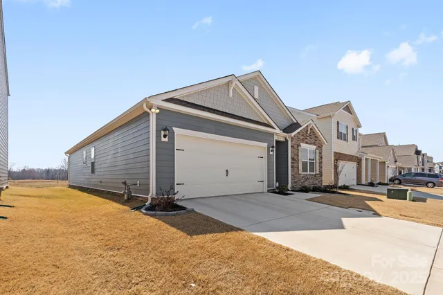 a view of a house with wooden fence