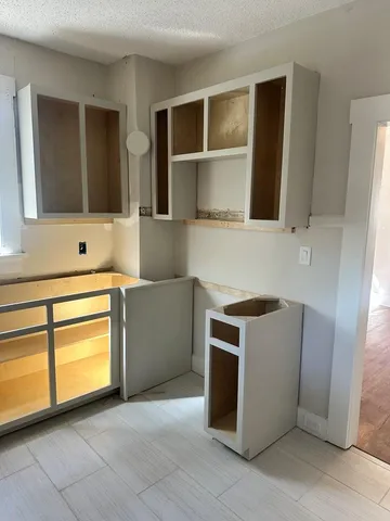 a kitchen with stainless steel appliances granite countertop a stove and a microwave