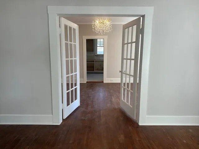 a view of hallway with wooden floor