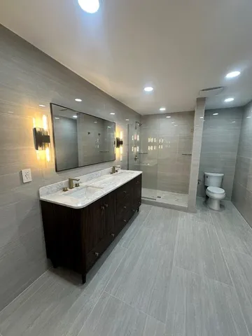 a spacious bathroom with a double vanity sink and a mirror