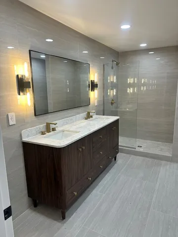 a bathroom with a sink double vanity and a mirror
