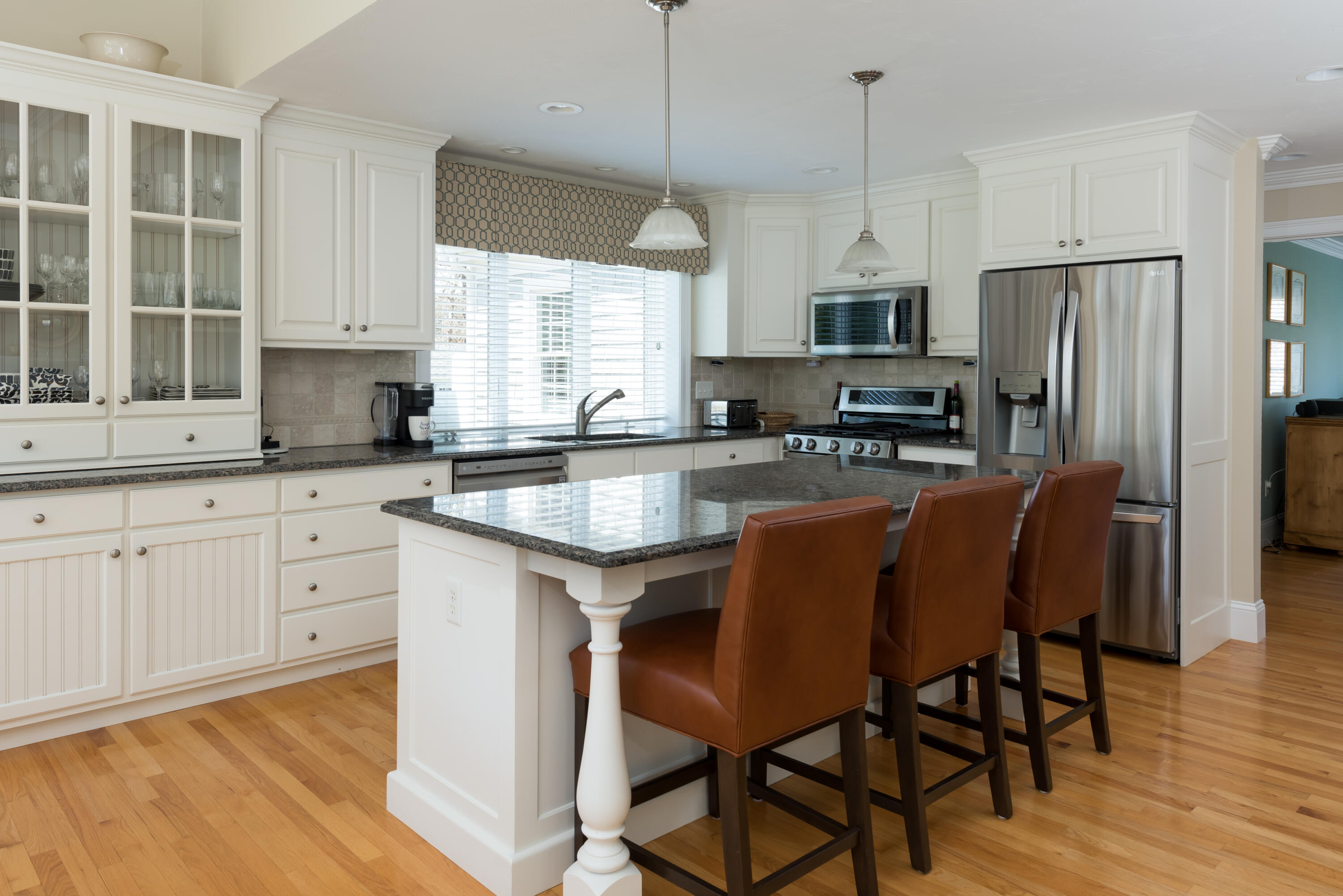 12 Somerset Road Harwich, MA 02645 - Photo 14 of 30 a kitchen with stainless steel appliances granite countertop a sink a stove a refrigerator cabinets a dining table and chairs