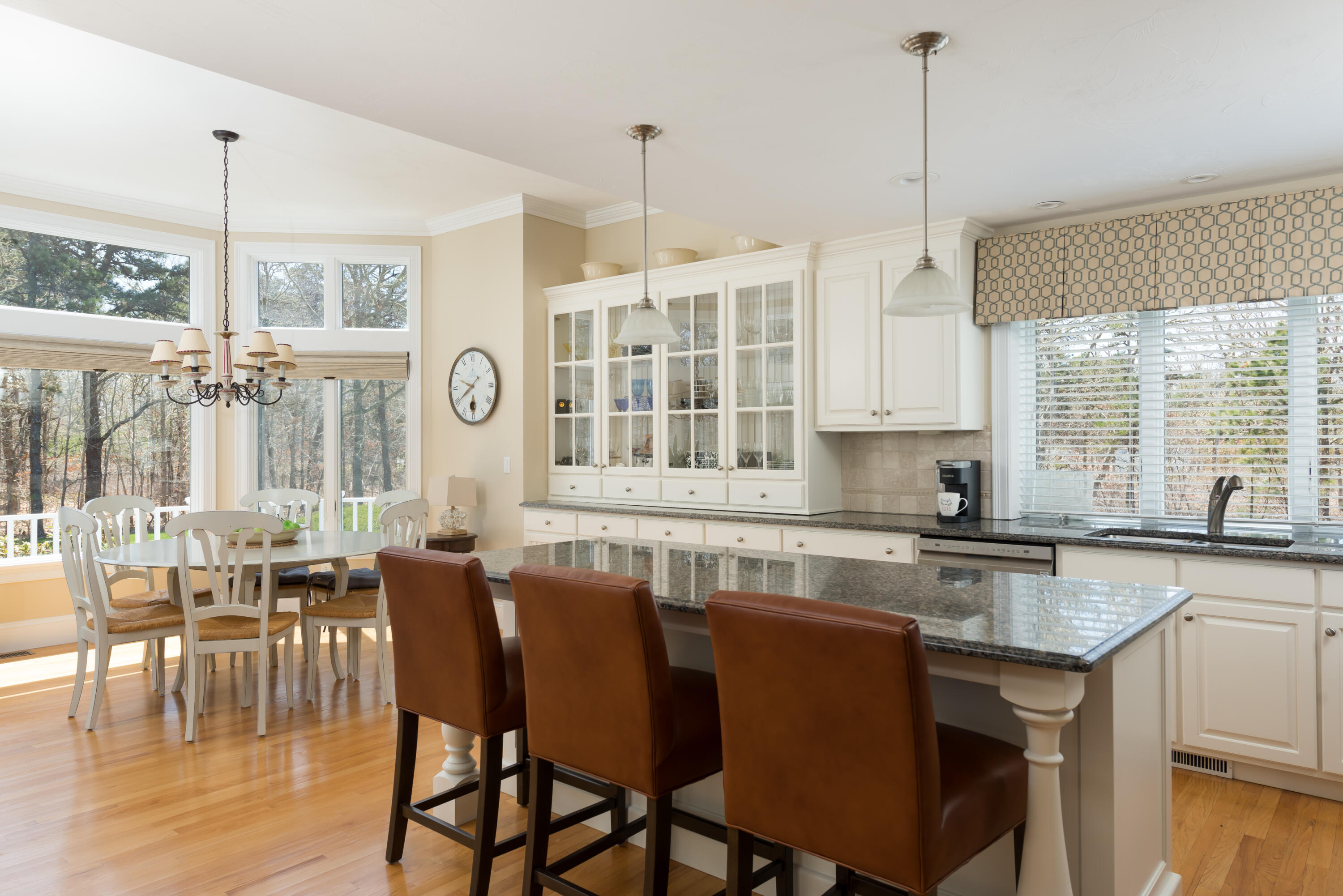 12 Somerset Road Harwich, MA 02645 - Photo 15 of 30 a kitchen with stainless steel appliances granite countertop a stove a refrigerator a kitchen island with a dining table and chairs