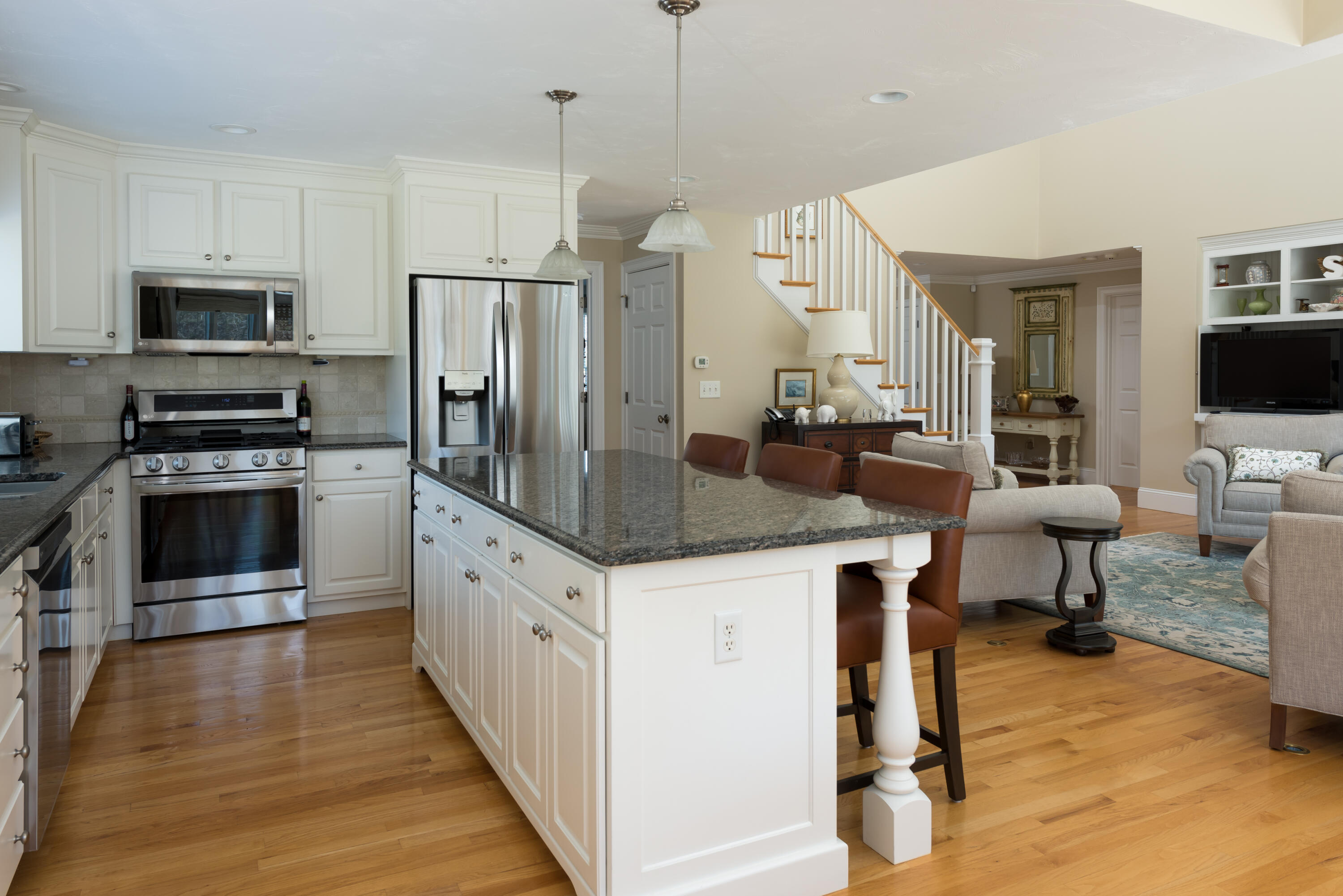 12 Somerset Road Harwich, MA 02645 - Photo 9 of 30 a kitchen with stainless steel appliances kitchen island granite countertop a sink a counter space and cabinets