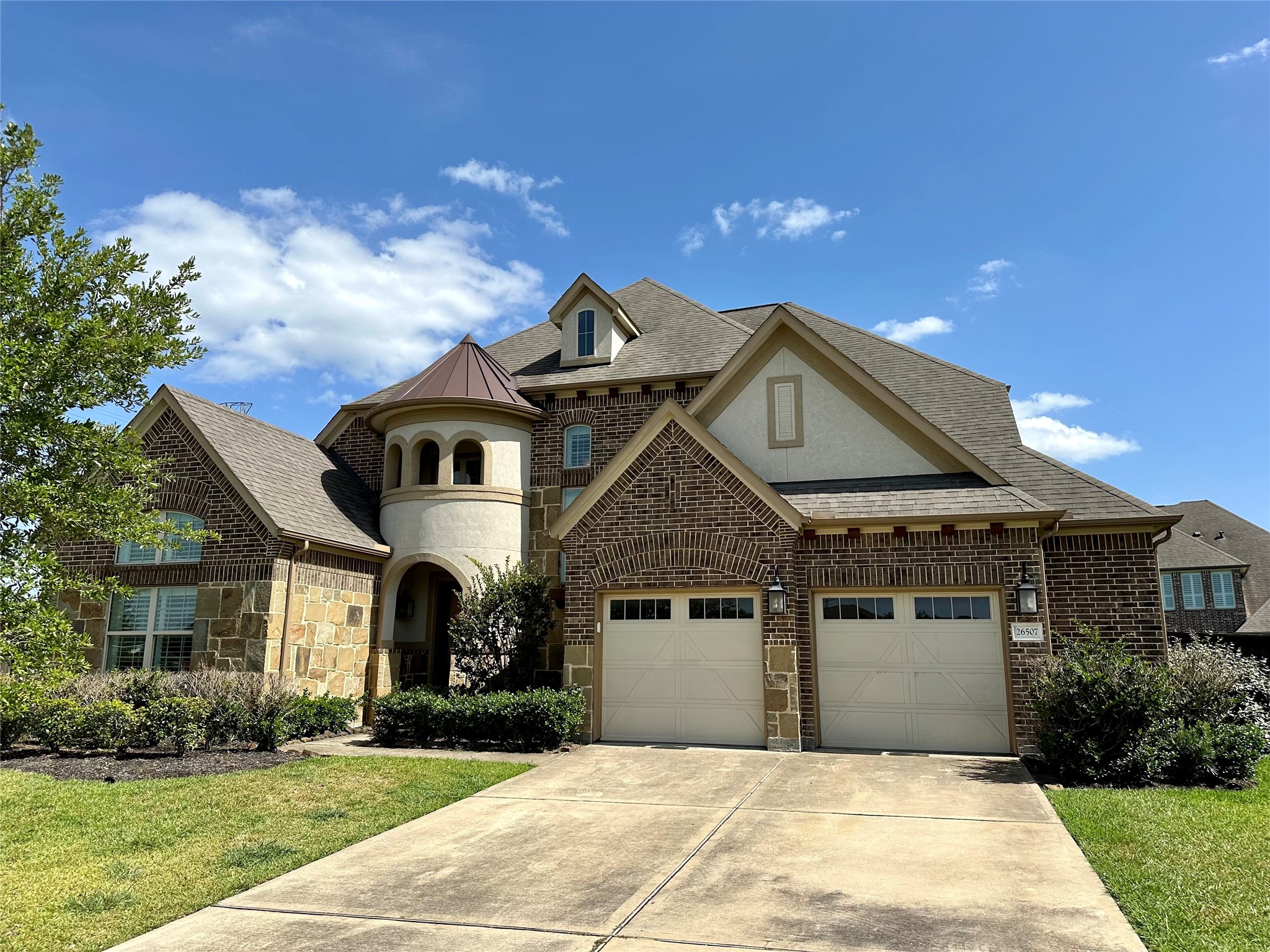 a front view of a house with a yard and garage