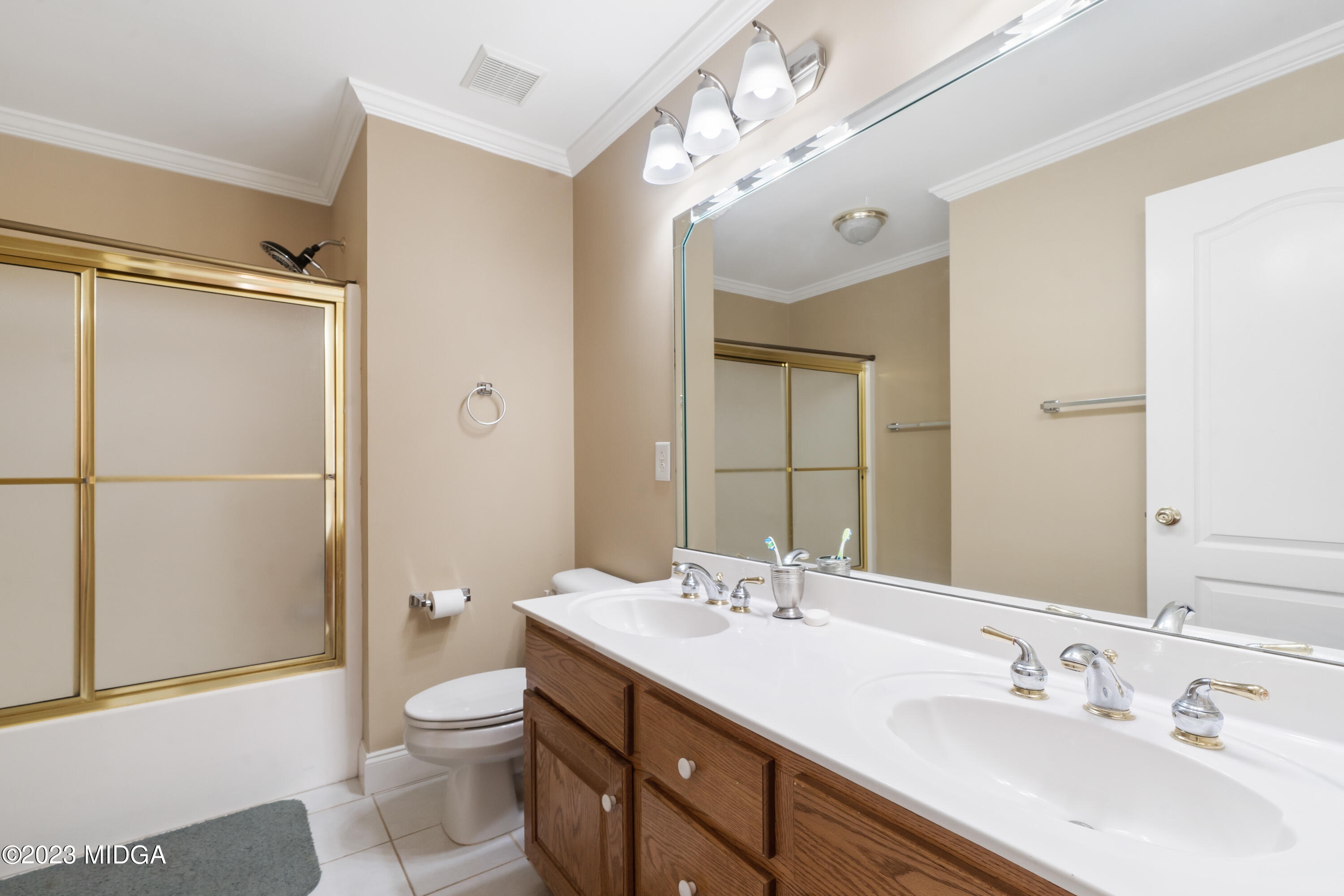 600 Flat Shoals Road Gray, GA 31032 - Photo 23 of 47 a bathroom with a sink toilet a mirror and shower