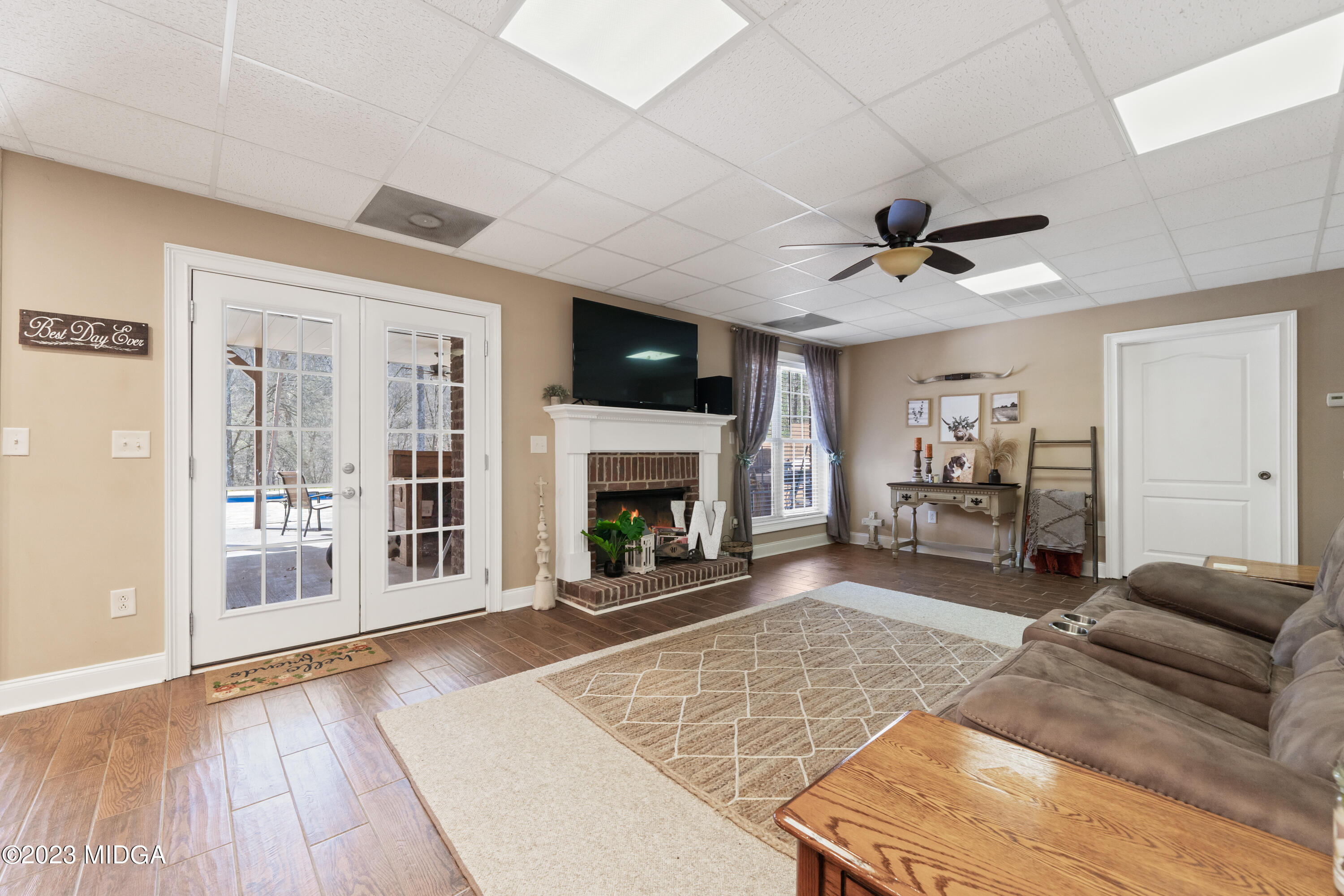600 Flat Shoals Road Gray, GA 31032 - Photo 35 of 47 a living room with furniture a fireplace and a flat screen tv