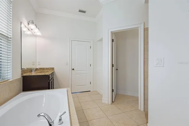 an empty room with a window and wooden floor