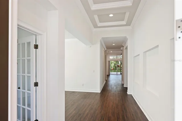 a view of a hallway with wooden floor