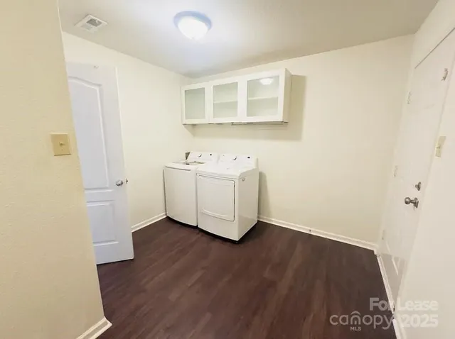 a view of a room with wooden floor and cabinet
