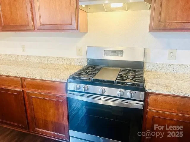 a stove top oven sitting inside of a kitchen