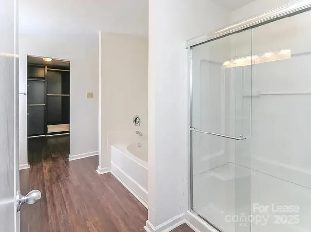 a bathroom with a bathtub and a shower