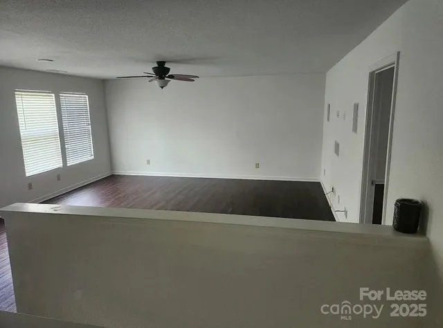 a view of a room with wooden floor