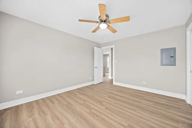 a view of room with wooden floor and fan