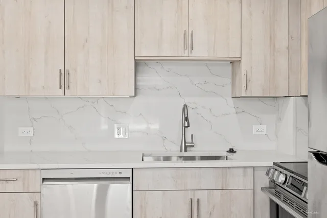 a kitchen with granite countertop white cabinets and a sink
