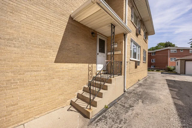 a view of a brick house with many windows