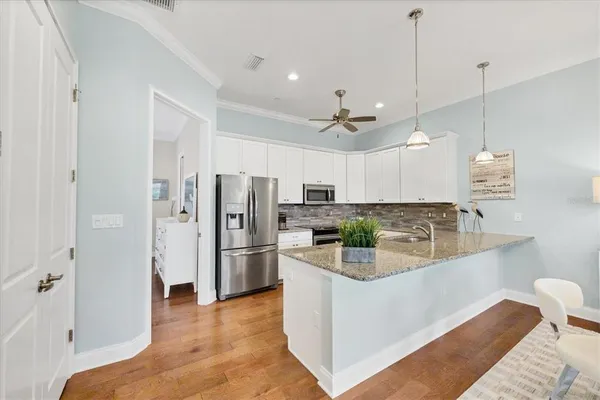 a kitchen with a sink refrigerator and cabinets