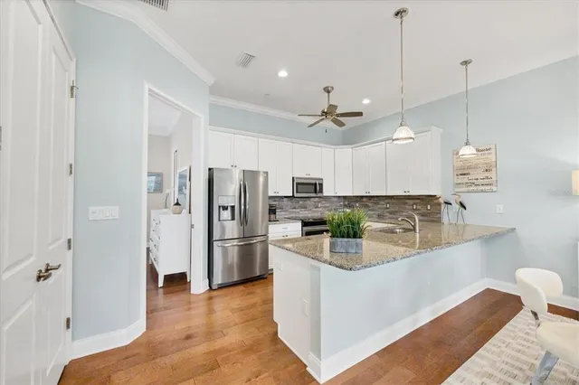 a kitchen with a sink refrigerator and cabinets
