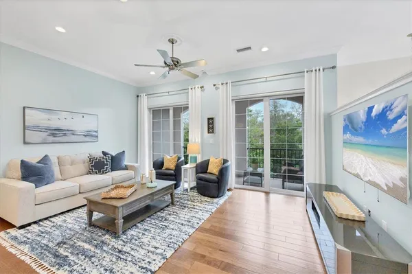a living room with furniture ceiling fan and a rug