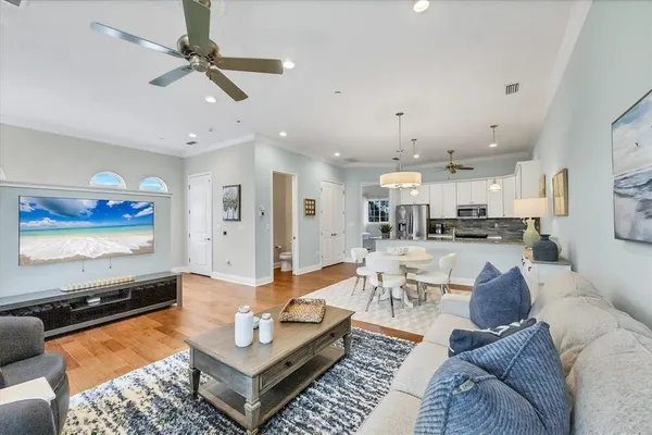 a living room with furniture and kitchen view