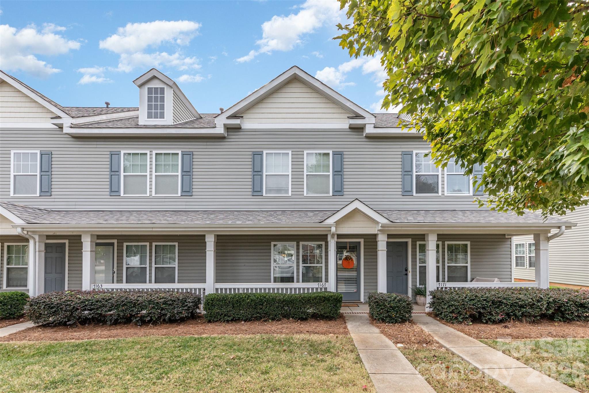 7167 April Mist Trail Huntersville, NC 28078 - Photo 2 of 19 a front view of a house with garden