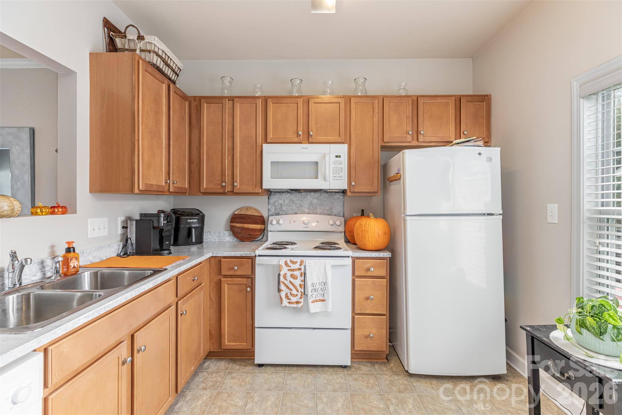 7167 April Mist Trail Huntersville, NC 28078 - Photo 6 of 19 a kitchen with a refrigerator a stove a washer and dryer