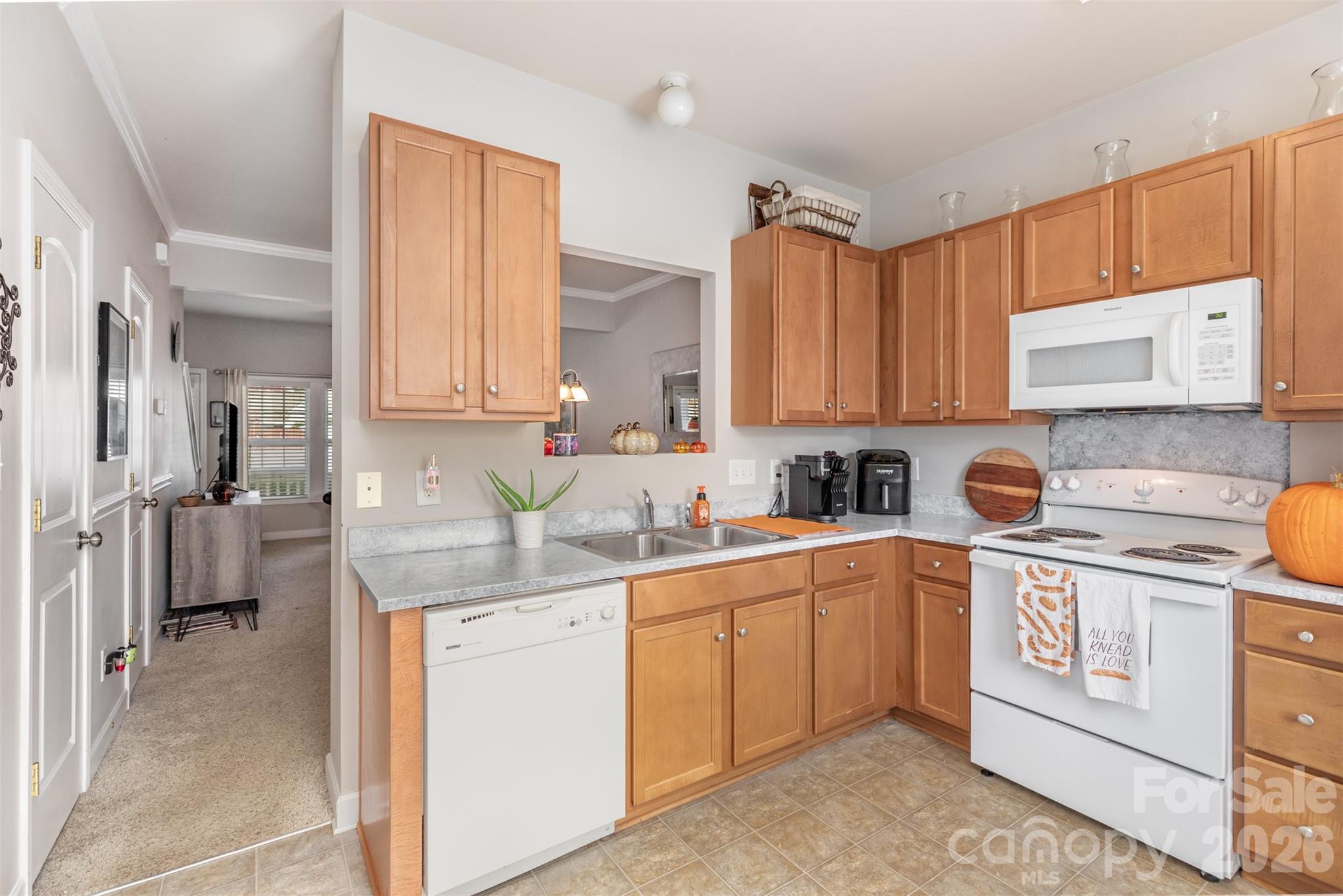 7167 April Mist Trail Huntersville, NC 28078 - Photo 7 of 19 a kitchen with a sink stove and cabinets