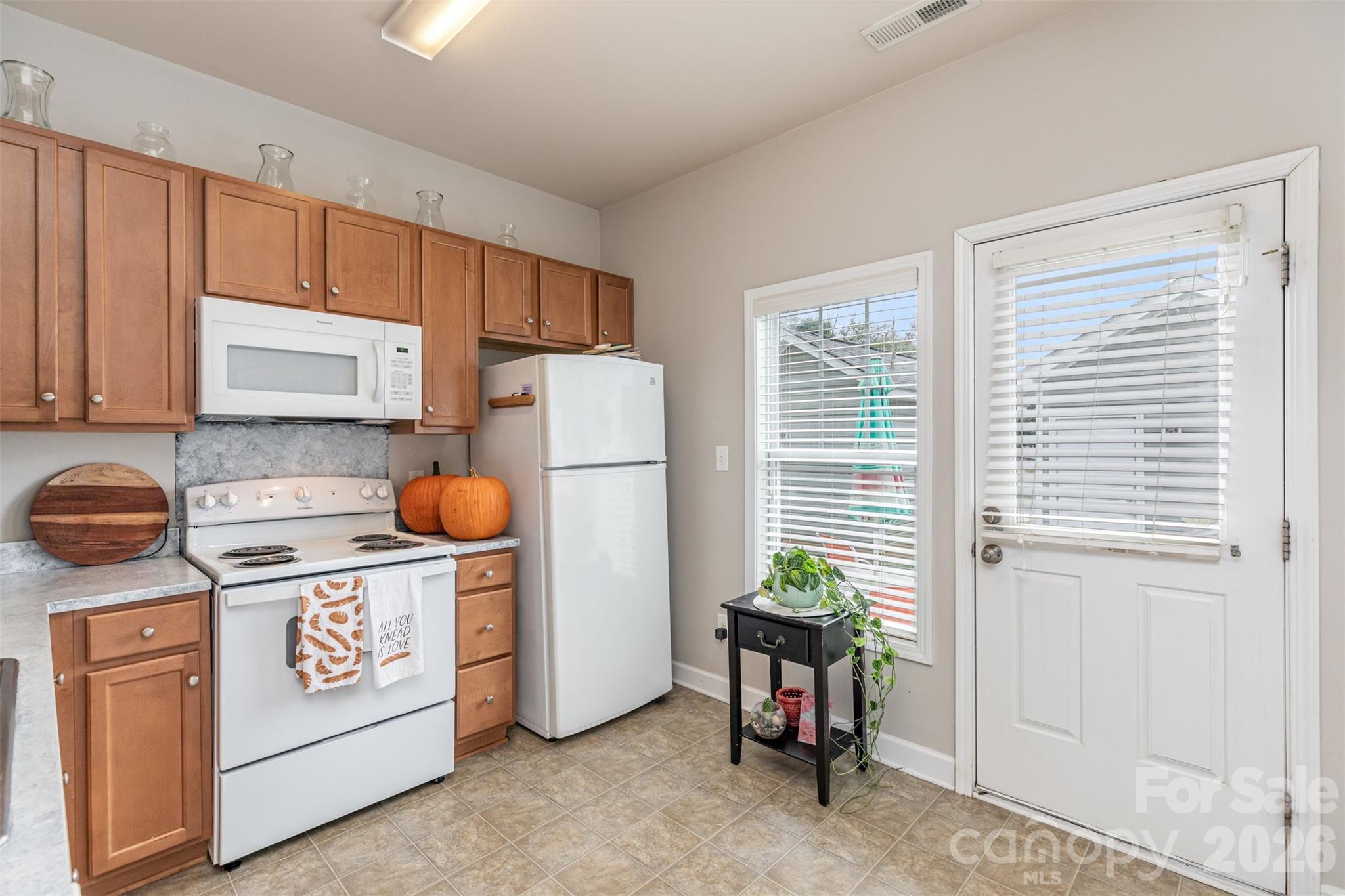 7167 April Mist Trail Huntersville, NC 28078 - Photo 8 of 19 a kitchen with a refrigerator and a stove top oven