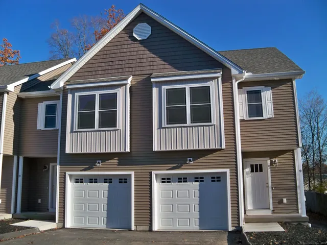 a view of a house with wooden fence