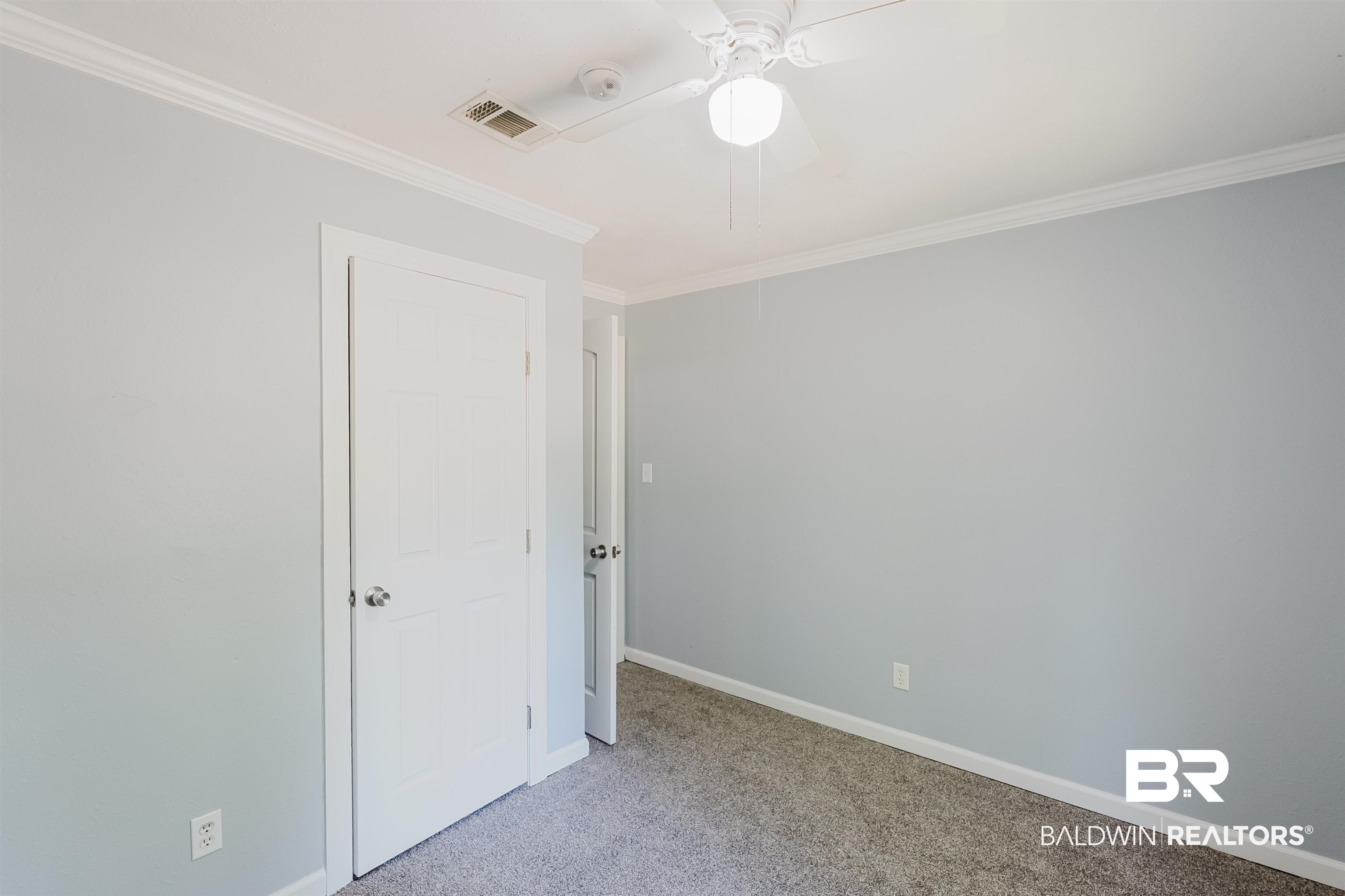 14185 Jackson Lane Foley, AL 36535 - Photo 10 of 16 Unfurnished room featuring light colored carpet, ornamental molding, and a ceiling fan