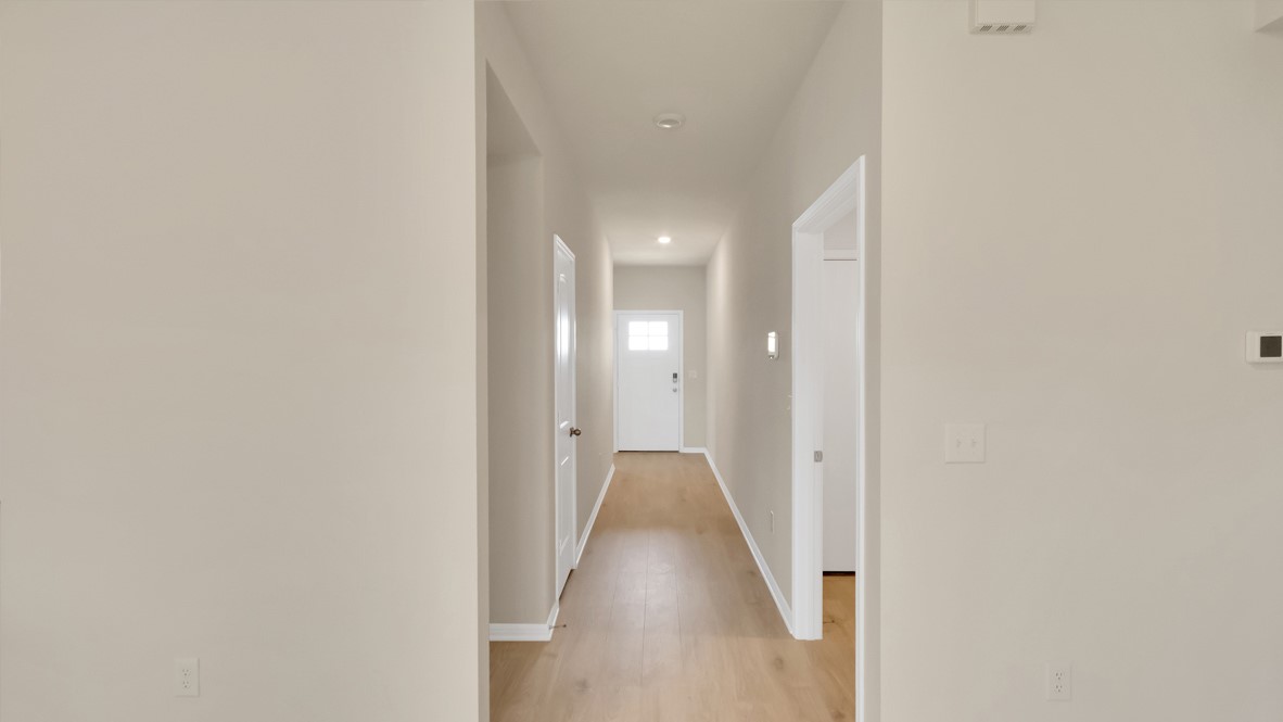 1817 Side Buster Trail Leander, TX 78641 - Photo 11 of 25 a view of a hallway with wooden floor