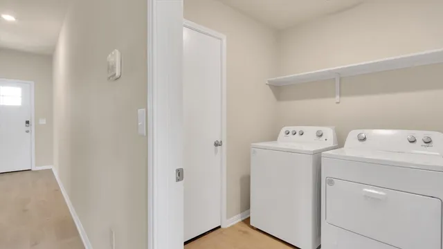 a view of storage and utility room with washer and dryer