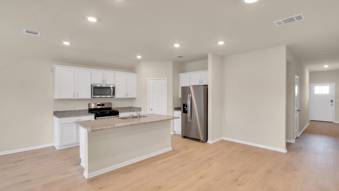 1817 Side Buster Trail Leander, TX 78641 - Photo 17 of 25 a kitchen with stainless steel appliances a refrigerator sink and microwave