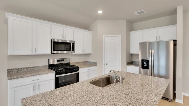 a kitchen with a sink stove and refrigerator