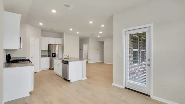 a kitchen with white cabinets and white appliances