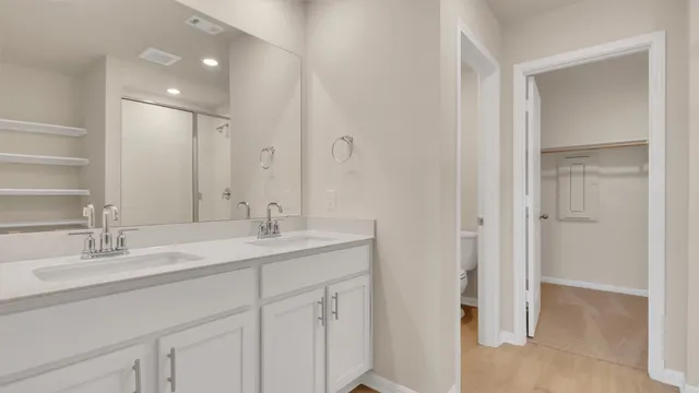 a bathroom with a sink double vanity and a mirror