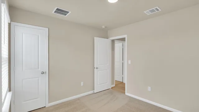 an empty room with closet area