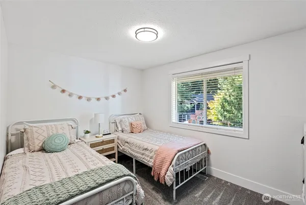 a bedroom with two beds and a window